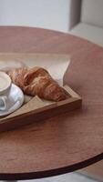 Enjoying a croissant and coffee in a cozy cafe setting video