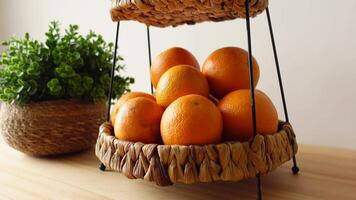 Fresh oranges displayed in a woven basket inside a kitchen video