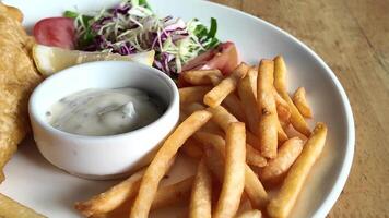 Delicious Fish and Chips Meal with Sauce and Fresh Salad Garnish video