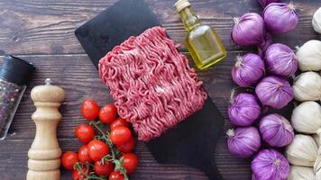 Fresh Ground Meat with Vegetables and Olive Oil on Wooden Background video