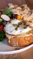 Delicious breakfast toast topped with eggs and seeds in cozy cafe video