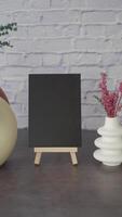 Creative desk setup with blank canvas and decorative vase video