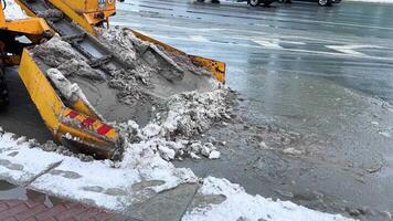 Municipal work. Machine remove slushy snow from streets after snowfall. Efficient snow management video
