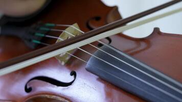 Closeup violin with bow glide smoothly on strings, performer precision of play. Classic instrument video