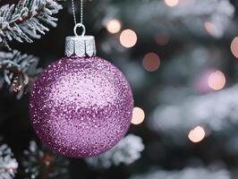 beautiful pink ornament hanging on snowy tree, surrounded by soft bokeh lights, creating festive and joyful atmosphere photo