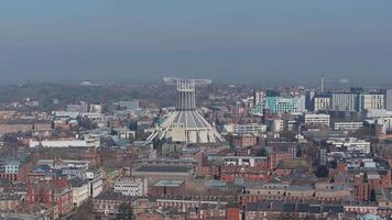 Aerial view of Liverpool's skyline featuring the Metropolitan Cathedral, historic and modern architecture, and a stadium under clear skies. video