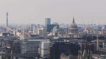 Aerial view of London with St. Paul's Cathedral in the foreground, modern skyscrapers, construction cranes, and a mix of historic and modern architecture. video