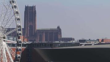 Aerial view of Liverpool featuring the Liverpool Wheel in the foreground and Liverpool Cathedral in the background with a slow pan or zoom motion. video