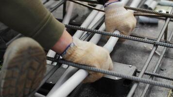 Worker installing conduit pipe into junction box under rebar video