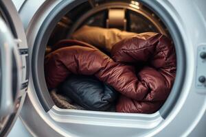 Winter jackets in front-loading washing machine before wash photo