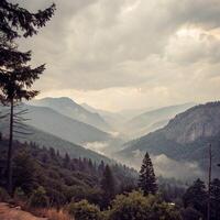 A view of a mountain range with trees and a sky photo