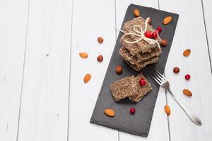 Homemade raw vegan dessert halva paste, healthy sweet food in the form of a solid mass of crushed almonds, hazelnuts and seeds. Top perspective view with place for text photo