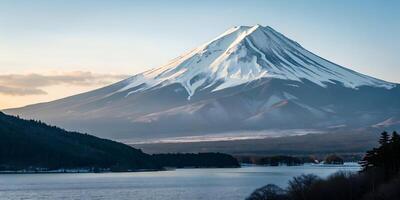 A snow-covered mountain with a cloudy sky, the mountain is large and imposing, with a mix of snow and rock visible photo