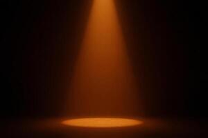 A beam of orange light shines down onto a circular spot on the ground, illuminating it brightly in a dark room photo