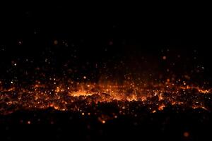 A pile of burning coal with embers and smoke against a black background, creating a dramatic and intense visual effect photo
