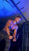 Athlete with strong body doing work out pushing up excercise in gym. View from the bottom. Blue light filter. Vertical video