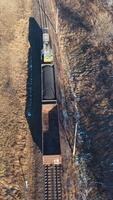 Aerial view of train on railway track through countryside video