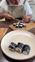 hands-on approach of making sushi, showcasing the practical skills and techniques involved in rolling, cutting sushi at home video