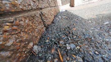 A wet sidewalk with gravel and rocks video