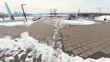 A view of the snow covered sidewalk in front of a building video
