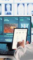 Vertical Healthcare professional sharing his expertise and interpreting the MRI scans results, offering advice and support to sick woman at checkup. Accurate diagnostics and patient care. Camera B. video