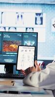 Vertical Healthcare professional sharing his expertise and interpreting the MRI scans results, offering advice and support to sick woman at checkup. Accurate diagnostics and patient care. Camera A. video