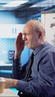 Vertical Healthcare physician sharing medical expertise and reading the MRI scan results with male patient, reviewing x ray reports for the correct diagnostic. Senior expert discuss treatment plans. Camera A. video