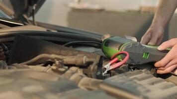 Auto service worker checking voltage on car battery. Service engineer working in car service station 2 video
