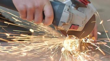 Close-up of grinder in use during car part maintenance with sparks. video