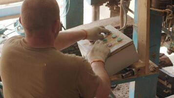 Worker sets the program with the control panel on an automatic woodworking machine with a CNC 2 video