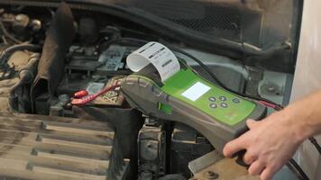 Auto worker using diagnostic scanner to analyze engine performance. video
