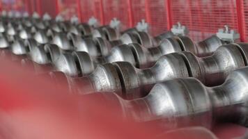 Close-up view of heavy-duty shaping rollers aligned on red-painted machinery frame. video