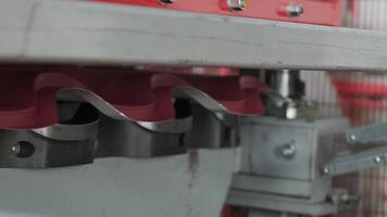 Detailed macro of metal profile being formed between compression dies in factory. video