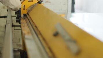 Close-up of a metal bending machine in operation, showing precise alignment of components for industrial sheet shaping video