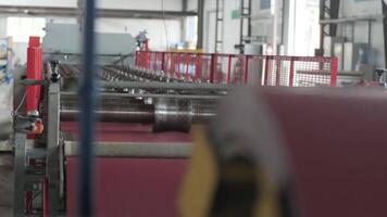 Industrial metal tile production machine with sheet feed entering the shaping rollers. video