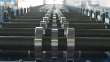 Symmetrical alignment of cylindrical rollers on a metal forming line for structural steel production. video
