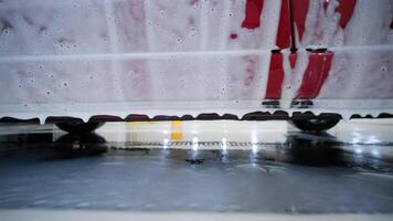 Thick foam dripping from lower part of car during undercarriage wash. video