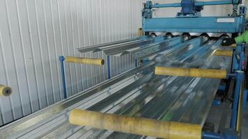 Metal sheets moving through automated conveyor for final processing. video
