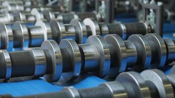Metal rollers processing sheet material in automated manufacturing system. video
