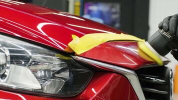 Tape mask setup and polish application on bumper edge near headlight. video