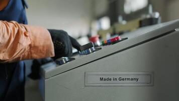 Worker operating industrial control panel with buttons and levers. video