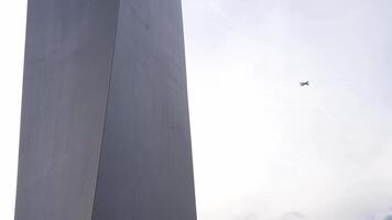 Close up of the the spike monument located at millennium dome or O2 arena with a plane flying in the sky. video