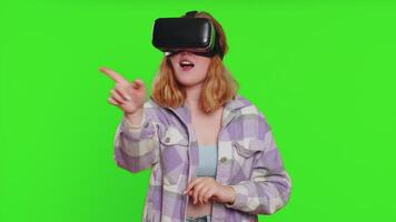 Excited woman in VR headset helmet watching virtual reality 3D , playing simulation online game video