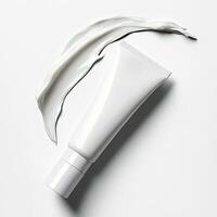 Creamy face cream spread on white surface from product tube. photo