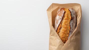 Freshly Baked French Baguette in Eco-Friendly Kraft Paper Bag on White Background photo