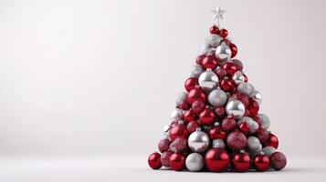 Christmas Tree Design Made Entirely From Red and Silver Ornaments on a Clean White Background photo