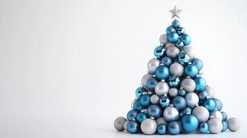Beautiful Blue and Silver Christmas Tree Made of Ornaments on a White Background photo