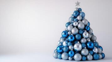 Elegant Blue and Silver Christmas Tree Created From Decorative Balls on a Clean White Background photo