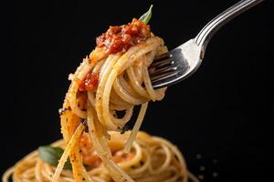 close-up Tasty spaghetti wrapped around fork on black background, HDR image photo