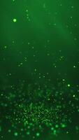 Gree particles twirling on the ground and flying in the air with light rays at the top left, vertical composition. Standard speed. Loop animation footage for graphic design. video
